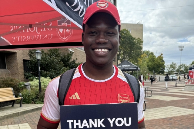 St. John's students holding Thank You signs for our donors generous donations