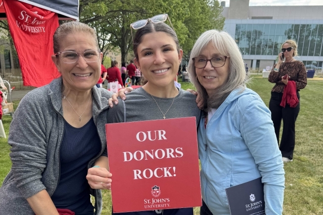 St. John's student holding Thank You signs for their generous donations