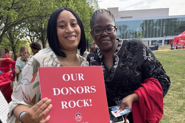 St. John's student holding Thank You signs for their generous donations