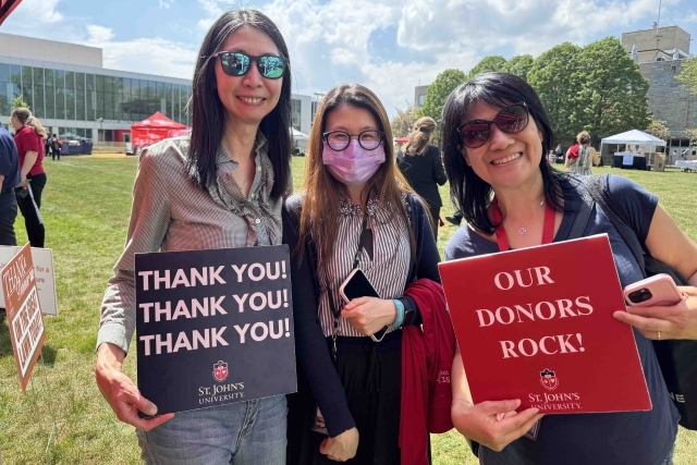 St. John's student holding Thank You signs for their generous donations