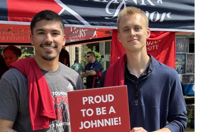 St. John's student holding Thank You signs for their generous donations