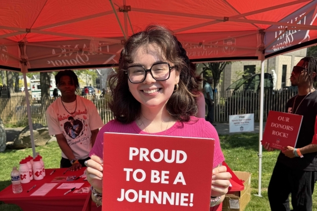 St. John's student holding Thank You signs for their generous donations