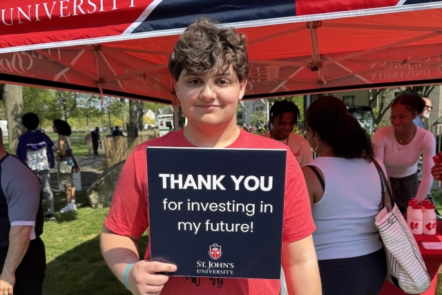 St. John's student holding Thank You signs for their generous donations