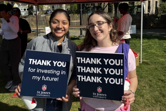St. John's student holding Thank You signs for their generous donations