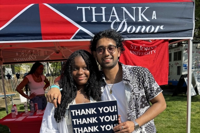 St. John's student holding Thank You signs for their generous donations