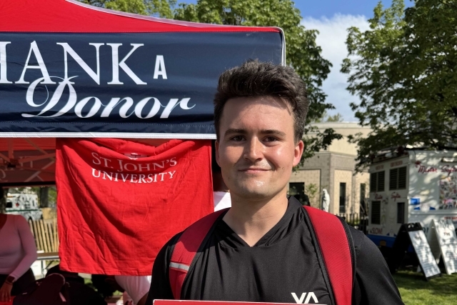 St. John's student holding Thank You signs for their generous donations