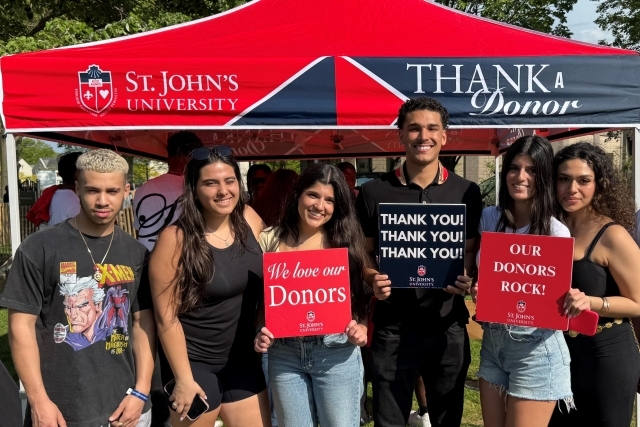 5 students holding signs thanking donors for their generous gifts