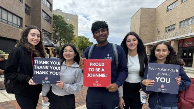 St. John's students holding Thank You signs for donors