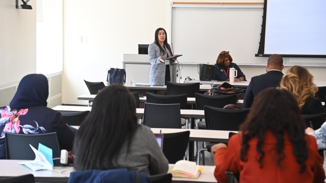 Teacher standing at podium teaching a lesson