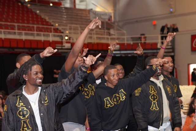 St. John's Fraternity members holding their hands up