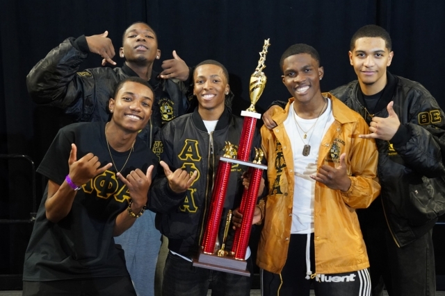 St. John's Fraternity members posing for photo holding a trophy
