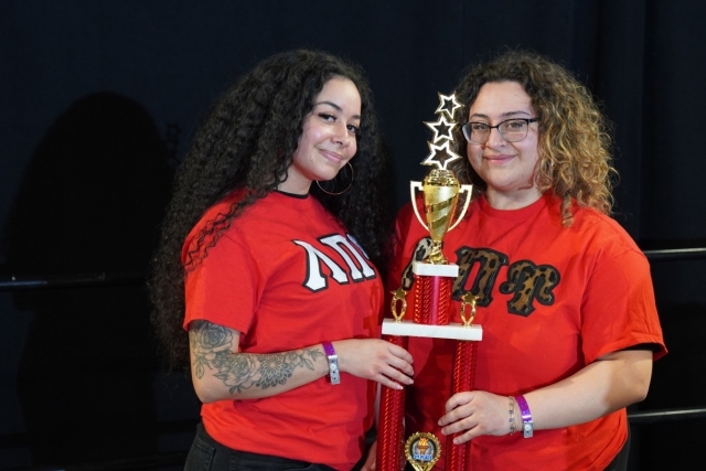 Two St. John's students holding a trophy