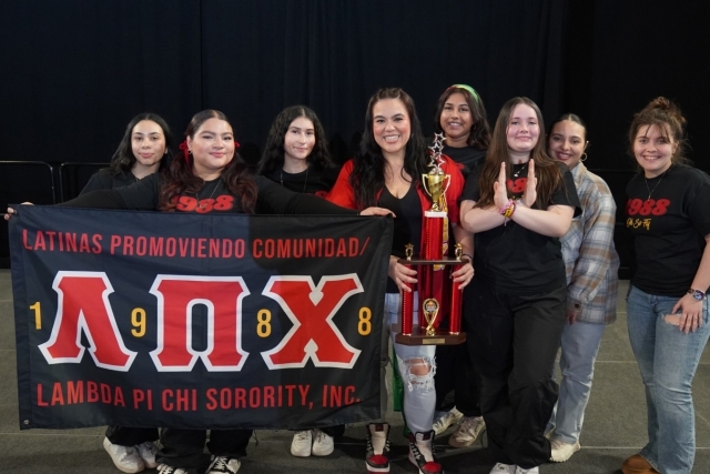 St. John's Sorority members posing for photo holding a trophy