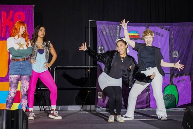 St. John's students in costume dancing on stage