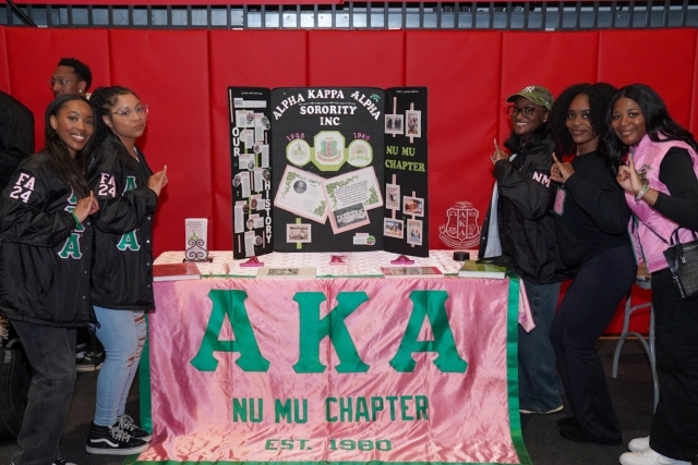 AKA St. John's Chapter students posing for a photo at their booth