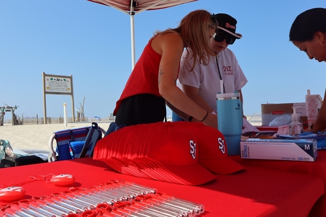 Signup tent for St. John's Alumni cleaning up the beach