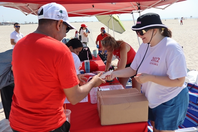 Signup tent for St. John's Alumni cleaning up the beach