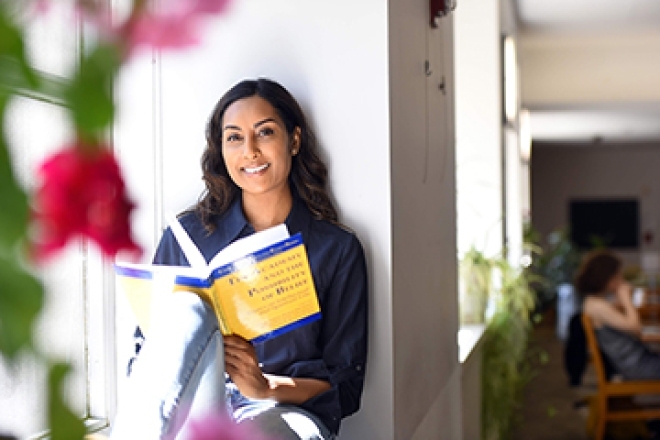Anna Jadonath sitting reading a book