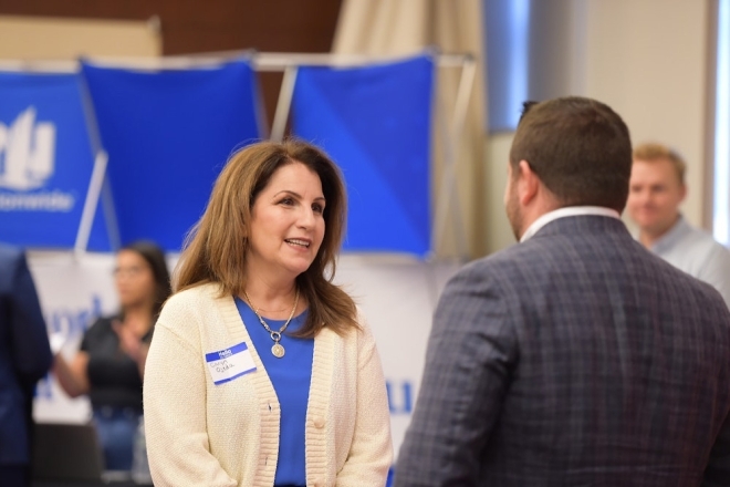 St. John's students speaking with industry experts at career fair