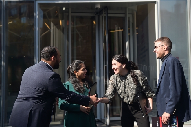 St. John's students shaking hands outside manhattan campus building