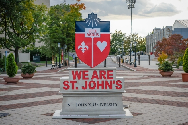 St. John's University Statue on the New York Campus with the words "We are St. John's"