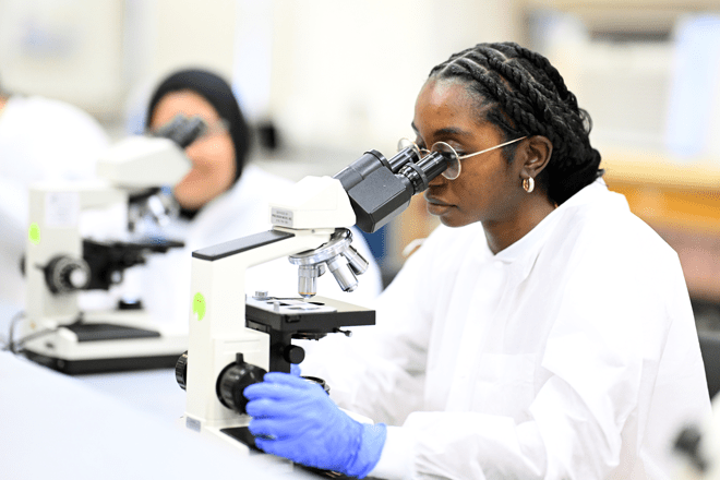 Students work together in a science laboratory, using lab equipment to prepare and analyze biological samples