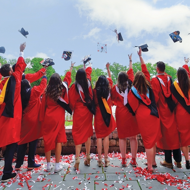 Graudates with back to camera caps in air