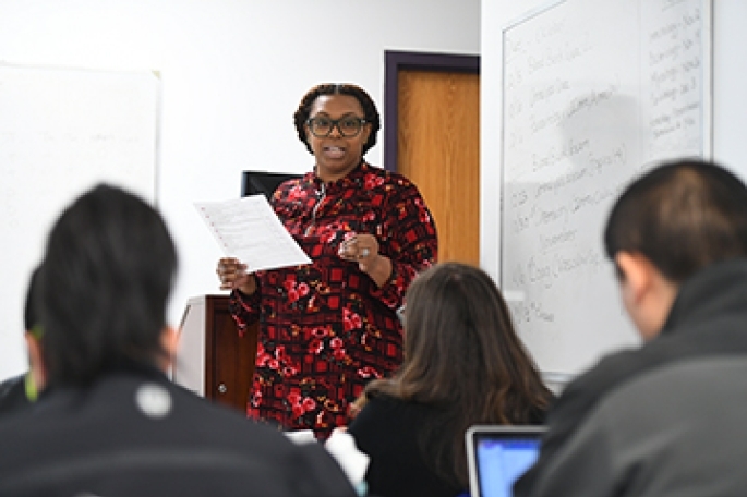 Female Professor teaching in front of whiteboard