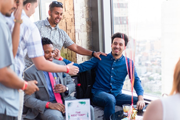 group of male alumni conversing