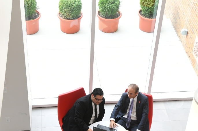 Two males working together on computer