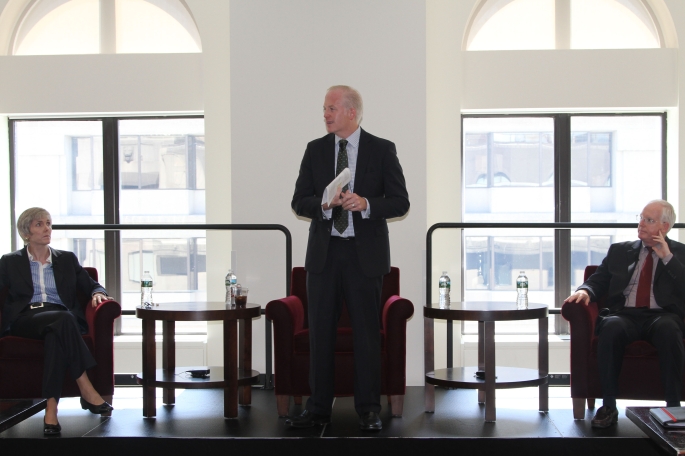 Three panelist members speaking to audience on stage
