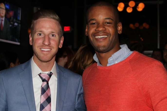 Two males posing for photo in bar