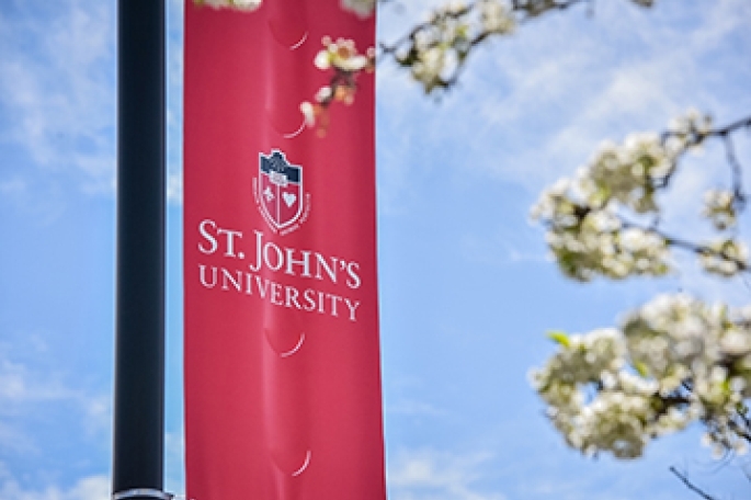 St. John's University logo on a red banner