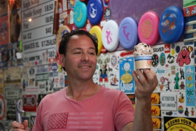 Male holding ice cream up in cup