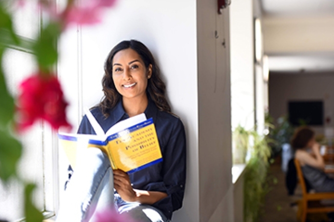 Anna Jadonath sitting reading a book
