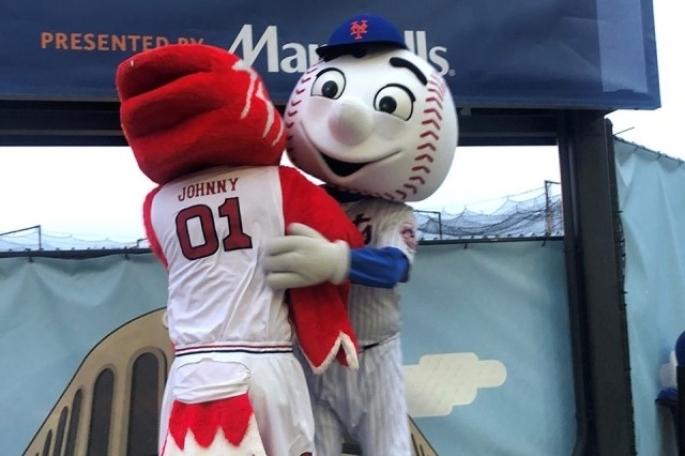 Johnny Thunderbird hugging Mr Met.
